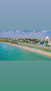 a view of a beach with umbrellas and the ocean at Caesar Resort SPA in Iskele