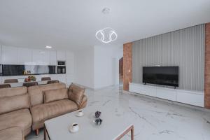 a living room with a couch and a tv at Villa Anida in Ulcinj