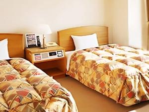 Una cama o camas en una habitación de 寝屋川トレンドホテル