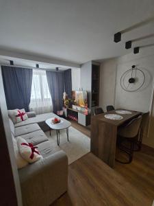 a living room with a couch and a table at Lu and Ma in Jahorina