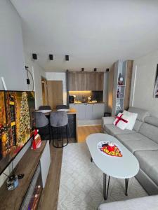 a living room with a couch and a table at Lu and Ma in Jahorina
