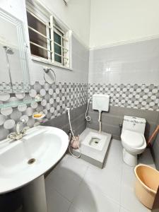 a bathroom with a sink and a toilet in it at Sky Lodge Guest House in Islamabad +46 photos