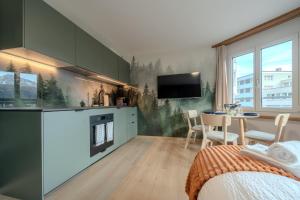 a room with a kitchen and a dining room at Collina Forest Design-Studio by Arosa Vacations in Arosa
