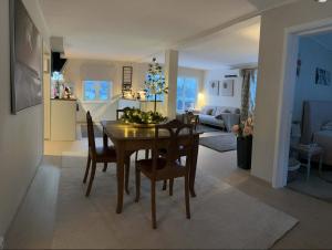 a dining room and living room with a table and chairs at Herb Farm Guesthouse in Senja