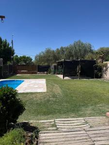 a yard with a pool and a fence at Osvaldo Day Cabin with Pool in Albardón