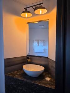 a bathroom with a bowl on a counter with a mirror at Motel Rimouski in Rimouski +44 photos
