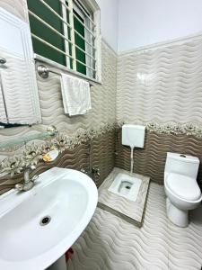 a bathroom with a sink and a toilet at Sky Lodge Guest House in Islamabad