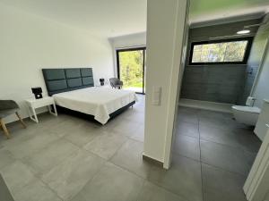 a bedroom with a bed and a tub and a sink at Villa Elodie Piscine privé, parking in Vau +28 photos
