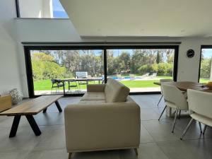 a living room with a couch and a table at Villa Elodie Piscine privé, parking in Vau