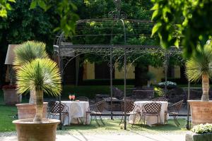 La Colombera Ristorante - Albergo في Castrezatto: فناء في الهواء الطلق مع طاولات وكراسي وحمام