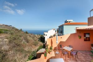 a patio with chairs and a table on a house at Casa Con Vista in La Guancha