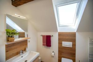 a bathroom with a sink and a window at Villa Harmonie - Apartment Jasmin in Borkum