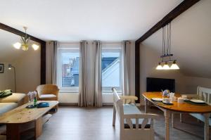 a living room with a table and a couch at Villa Harmonie - Apartment Jasmin in Borkum +17 photos
