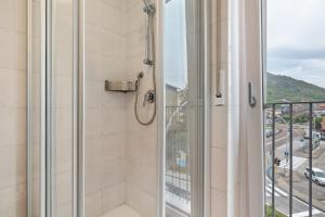 a bathroom with a shower with a view of a street at La casa di Romi in Mori +21 photos