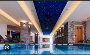 a swimming pool in a hotel with a star ceiling at Caesar Resort SPA in Iskele