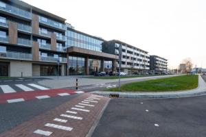 an empty street in front of a large building at SPV Rentals Pileckiego 59 lokal 258 free Parking Ursynów in Warsaw