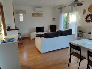 a living room with a white couch and a table at Oleanda in Port d'Alcudia