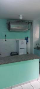 a kitchen with a counter top with a refrigerator at Afsaal 214 in Amanzimtoti +6 photos