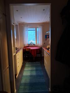 een keuken met een tafel met een rode tafellaken bij Warm Nest in Rovaniemi