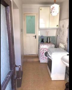 a kitchen with a white door and a sink at Sweet house in Gyumri