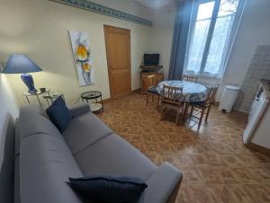 a living room with a couch and a table at Lys in Bourbonne-les-Bains