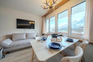a living room with a table and a couch at 2 Design-Studios im Zentrum by Arosa Vacations in Arosa +16 photos