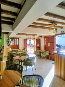a restaurant with tables and chairs in a room at Hotel Boutique Cenit in Villa de Leyva
