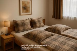 two twin beds in a bedroom with a lamp on a table at Burgfräulein in Hardegg