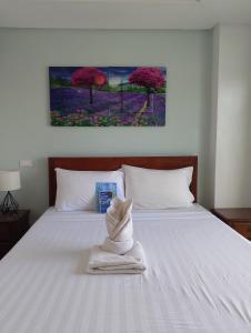 a bedroom with a bed with a towel on it at Aqua Travel Lodge in El Nido +35 photos
