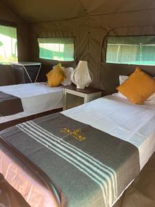 Ένα ή περισσότερα κρεβάτια σε δωμάτιο στο Dinkoeng Tented Camp & Adventure