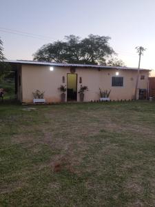 a white building with a yard in front of it at Ulises House in Luque