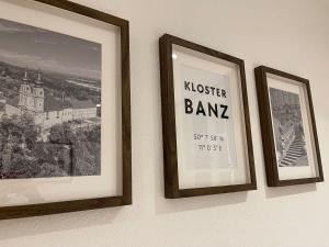three framed pictures hanging on a wall at Juraperle - Historisch und modern - Wohnung 1 in Bad Staffelstein