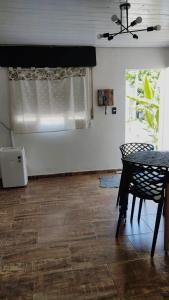 a living room with a table and a window at Casa Marty 2 in Ezeiza