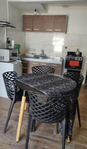 a kitchen with a table and chairs in a kitchen at Casa Marty 2 in Ezeiza
