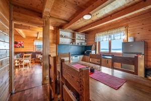 a kitchen and dining room of a log cabin at Chaty Lipa in Levoča
