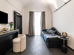 a living room with a couch and a chair at Dimora San Nicola Charming Suite in Conversano