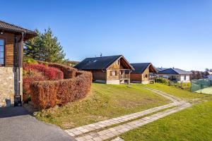 a group of houses in a yard with bushes at Chaty Lipa in Levoča