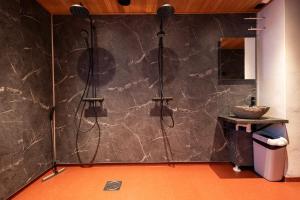 a bathroom with a shower and a sink at Arctic Guesthouse in Ranua +36 photos