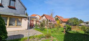 a group of houses in a yard next to a house at Ferienhaus Rosengarten in Blankenburg