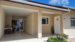 a house with a porch and a door at Casa para 7 Pessoas em Bombas 600 m da Praia in Bombinhas