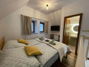 a bedroom with a bed with yellow pillows on it at Apartmány pod Štěpánkou in Kořenov