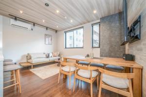 a kitchen and living room with a table and chairs at Restia Solace in Sapporo