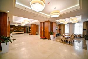 a lobby of a hotel with a table and chairs at Ararat Resort Tsaghkadzor in Tsaghkadzor