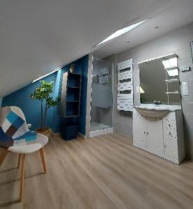 a bathroom with a sink and a mirror at Chambre spacieuse climatisée - Petit déjeuner inclus in Euville