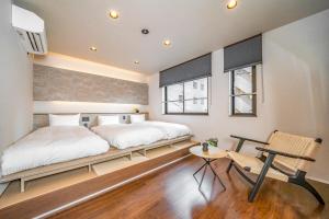 a bedroom with a bed and a desk in it at Restia Solace in Sapporo