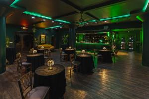 a room with tables and chairs and green lights at Haywood Park Hotel, an Ascend Collection Hotel in Asheville