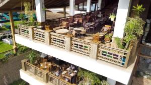 an overhead view of a building with plants and tables at Noora Resort 