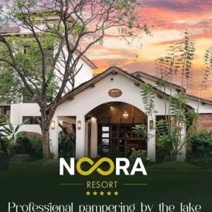a house with the nora resort logo in front of it at Noora Resort 