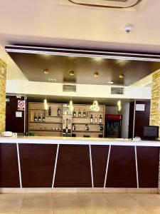a lobby with a bar in a restaurant at Hotel Poem Calarasi Ballroom in Călăraşi +14 photos