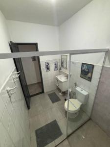 a bathroom with a toilet and a sink at Refúgio Pérola Capixaba in Marataizes +28 photos